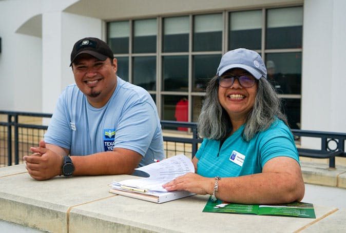 Two volunteers help with registration
